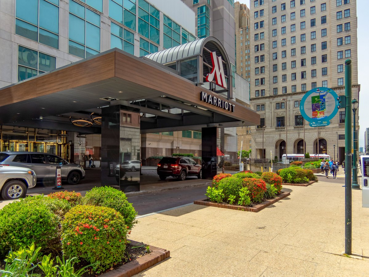 The Marriott entrance in downtown Philadelphia, with its canopy, signage and planted sidewalk.